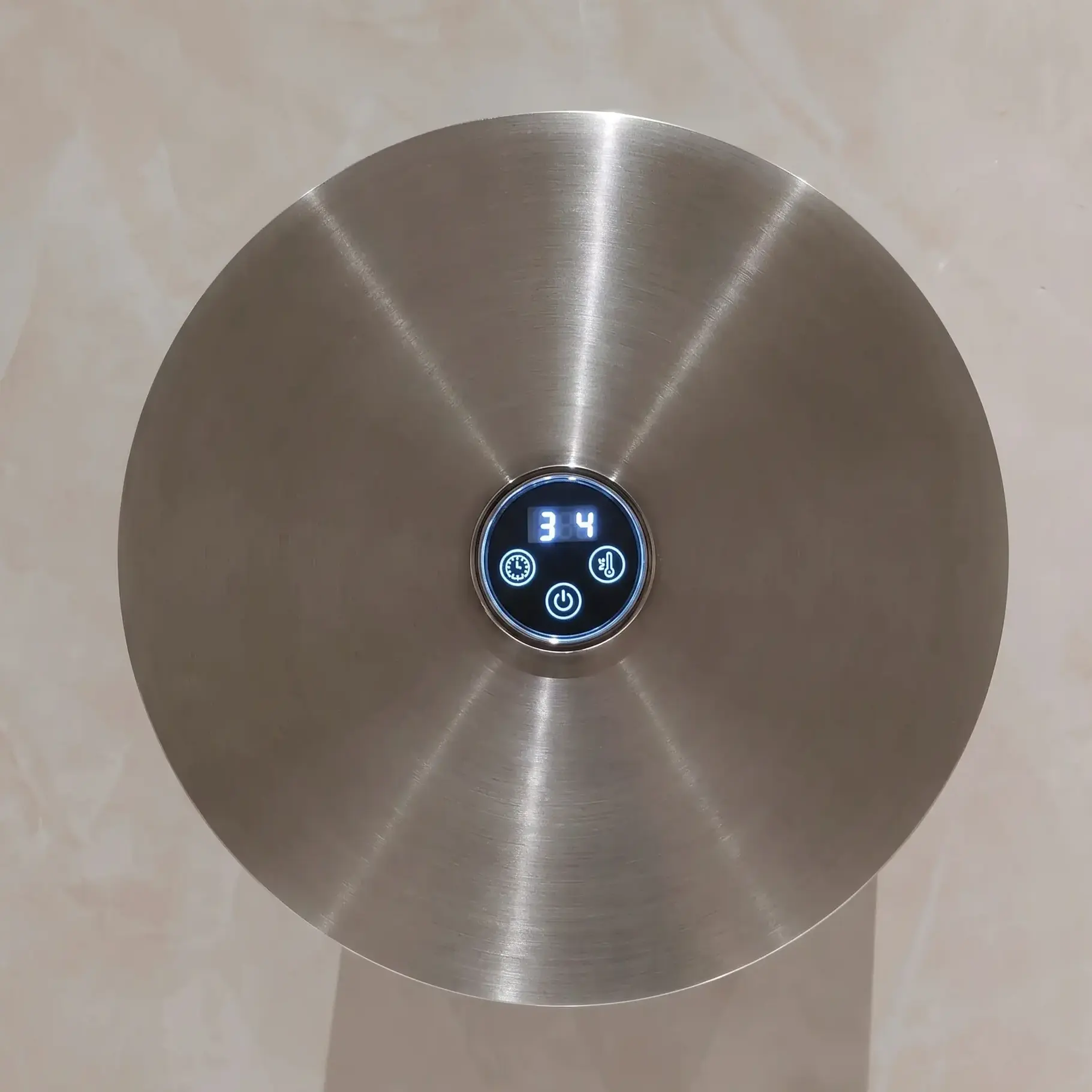 Sèche-serviettes électrique mural de forme ronde diamètre 21cm, finition acier inoxydable brossé.